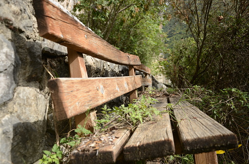An old wooden bench inside a footpath in zagorochoria