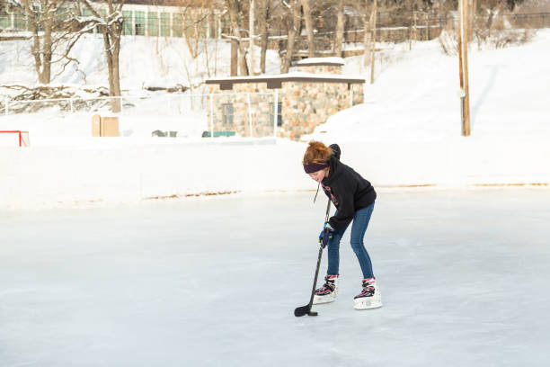 istock Girl Practicing Ice Hockey on Winter Day 1499027301