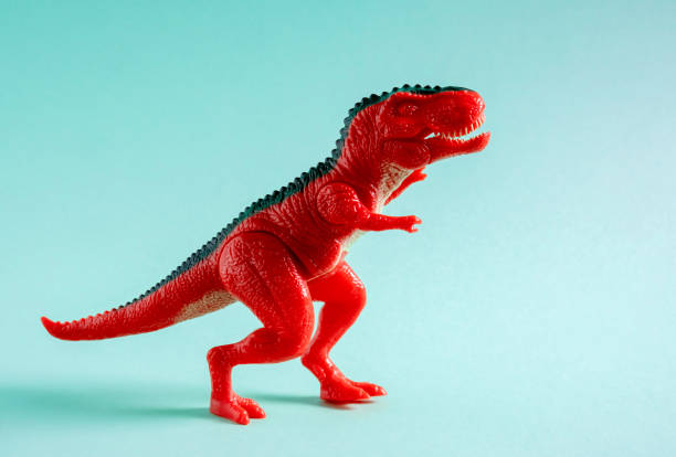 istock Red dinosaur toy on blue background. 1499028658