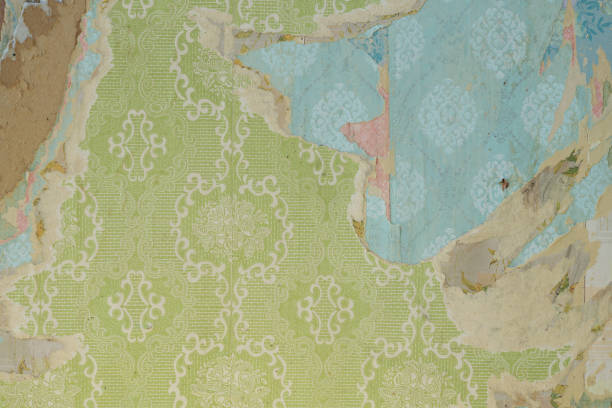 istock Old wallpaper on the wall. Old torn wallpaper for texture or background. 1499028868
