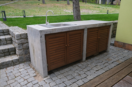 Concrete table with sink and water tap. Outdoor concrete table. Concrete outdoor furniture.