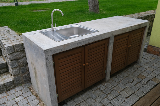 Concrete table with sink and water tap. Outdoor concrete table. Concrete outdoor furniture.