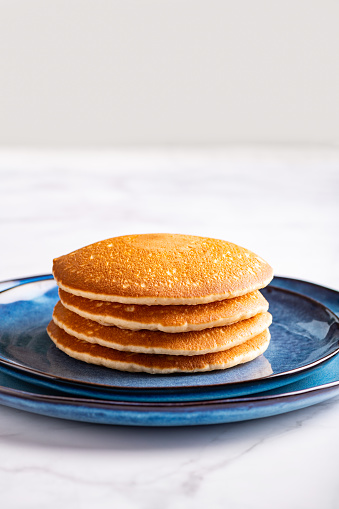 Fresh American Pancakes on blue plate and white background