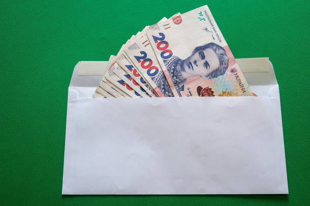 istock 200 Ukrainian hryvnias in a white envelope on a green background 1499035537