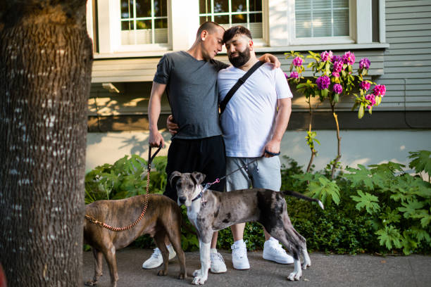 istock Two Affectionate Gay Men Walking With Their Pet Dogs 1499037160