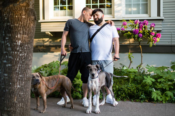 istock Two Affectionate Gay Men Walking With Their Pet Dogs 1499037171