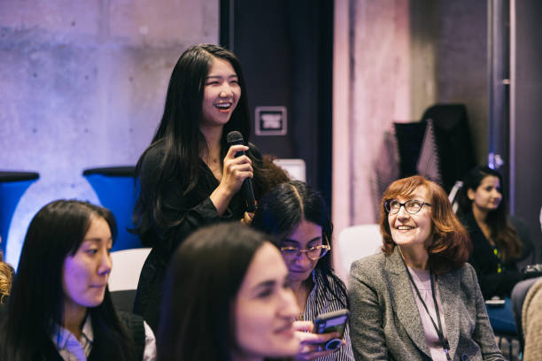 istock Businesswoman asking a question from a entrepreneur on conference stage 1499038740