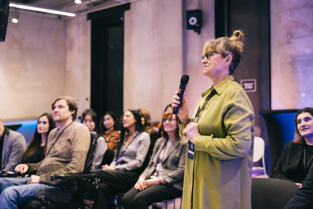 istock Businesswoman asking a question from a entrepreneur on conference stage 1499038744