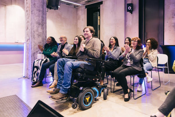 istock Diverse audience applauding successful presentation at tech conference. 1499038755