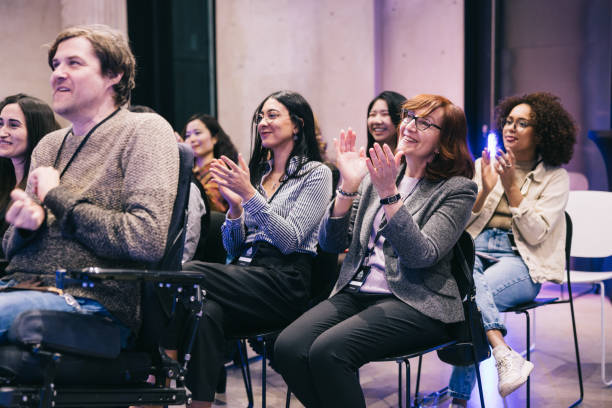 istock Diverse audience applauding successful presentation at tech conference. 1499038760