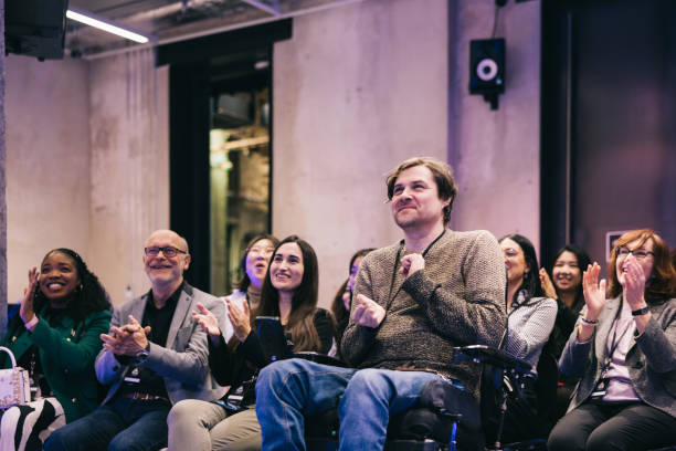 istock Diverse audience applauding successful presentation at tech conference. 1499038765