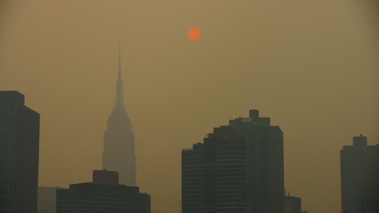 Manhattan Buildings In Heavy Yellow Haze With Diffused Sun