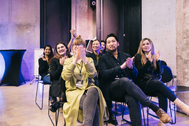 istock Diverse audience applauding successful presentation at tech conference. 1499038773
