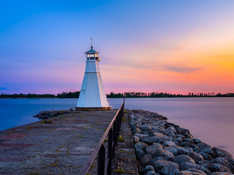 Historic lighthouse in a colorful sunset at Lake Vattern in Vadstena, Sweden.