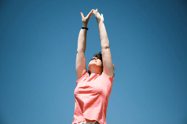 istock Smiling mature woman is exercising on water's edge 1499043972