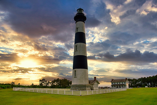 A Spring landscape of the Bodie Island Lighthouse in a cloudy sunset in North Carolina in the U.S.