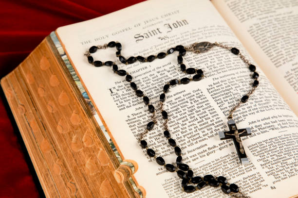 istock Holy Bible and Rosary Beads on a red velvet background 1499050921