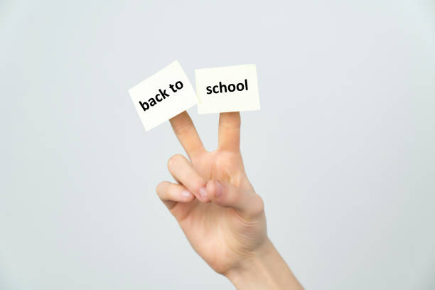 back to school. Pointing hand with sticker on finger