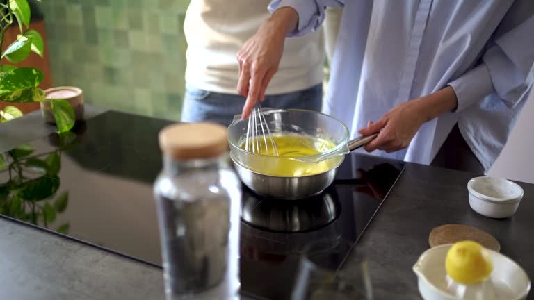 Couple making food together in kitchen