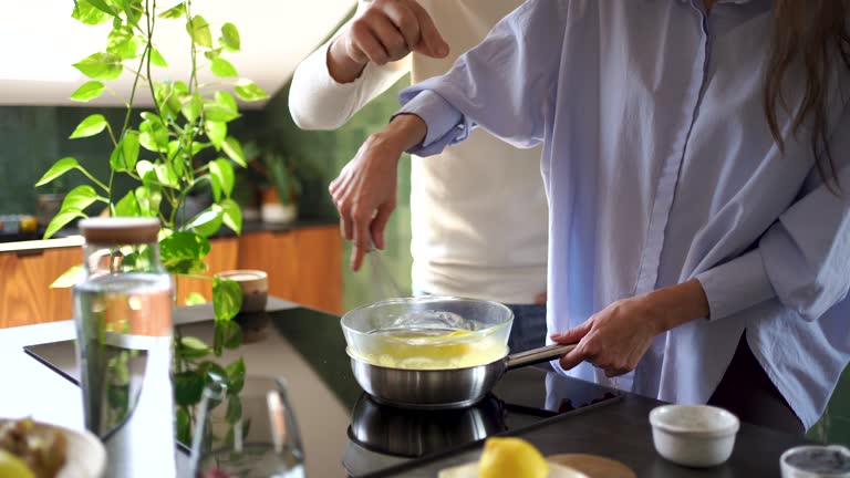 Couple making food together in kitchen