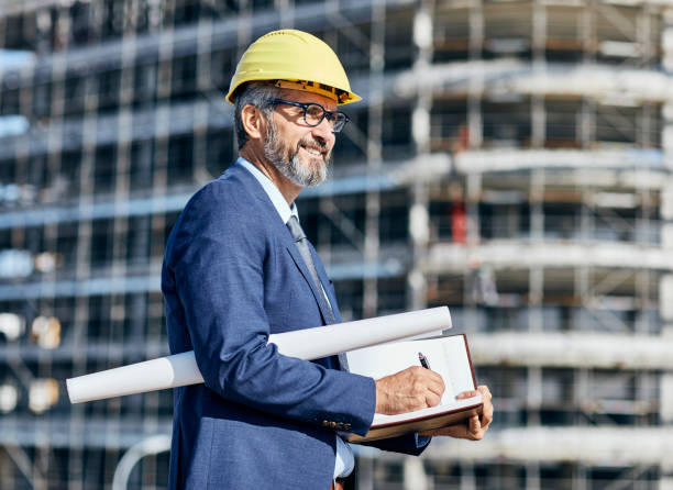 istock senior businessman architect helmet construction site building architecture tablet computer protective workwear blueprint plan 1499054806