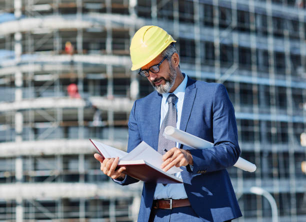 istock senior businessman architect helmet construction site building architecture tablet computer protective workwear blueprint plan 1499054909