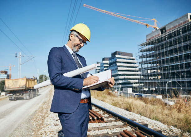 istock senior businessman architect helmet construction site building architecture tablet computer protective workwear blueprint plan 1499054948