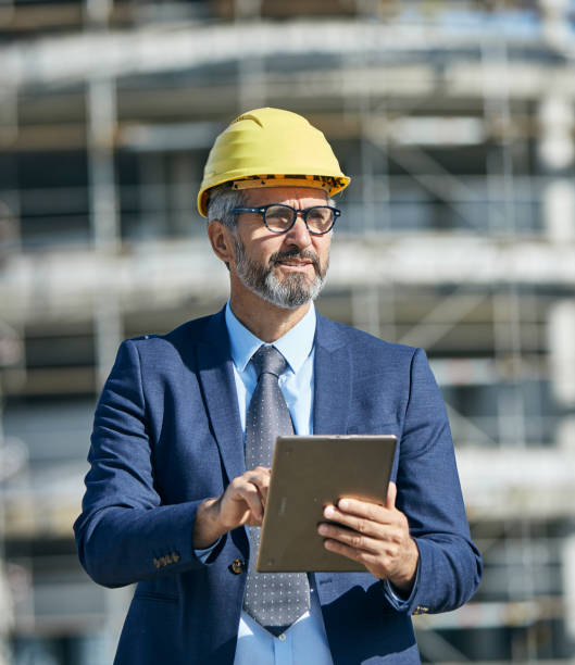 istock businessman construction site business architect building engineer builder tablet helmet architecture blueprint worker man contractor adult engineering industry 1499054962