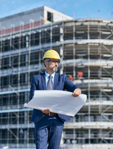 istock senior businessman architect helmet construction site building architecture tablet computer protective workwear blueprint plan 1499054971