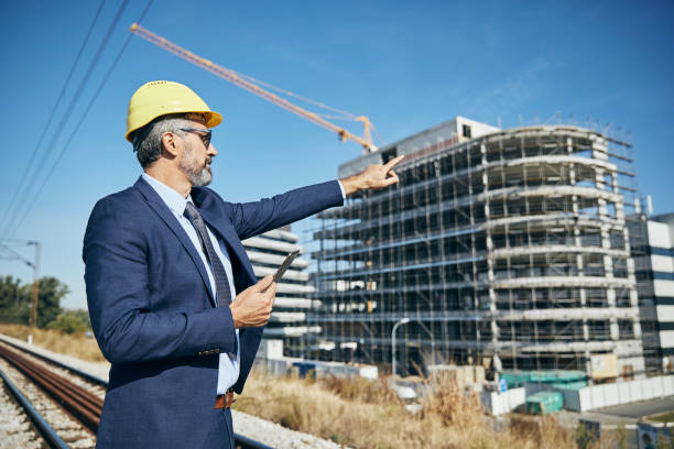 istock businessman construction site business architect building engineer builder tablet helmet architecture blueprint worker man contractor adult engineering industry 1499055039