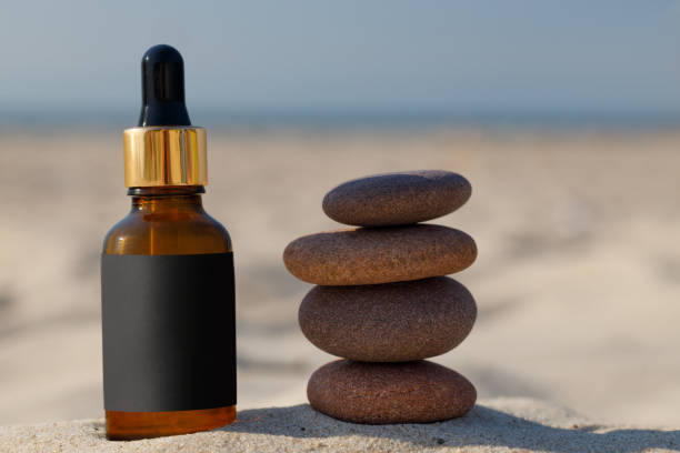 istock Natural calming product bottle at beach. Concept with blank label. 1499055430