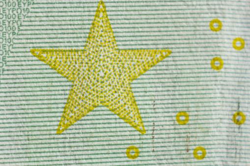 Protective watermark on a hundred euro bill in macro. protection against counterfeiting of banknotes. hologram. detail of paper money close up.