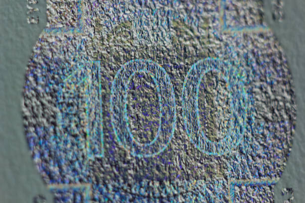 Protective watermark on a hundred euro bill in macro. protection against counterfeiting of banknotes. hologram. detail of paper money close up.