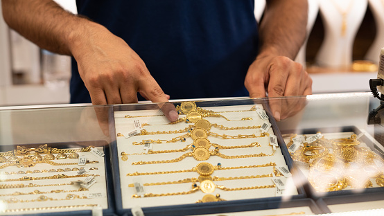 Jeweler man showing gold