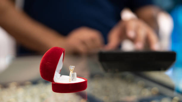 istock Heart shaped ring box stands on jeweler's table 1499056165