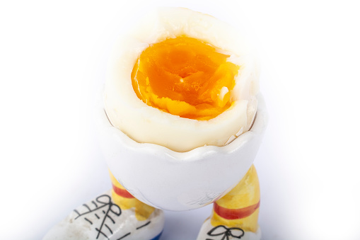 boiled egg open half in stand in the form of legs isolate