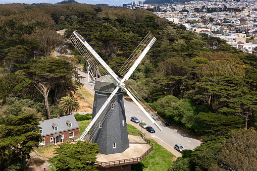 An aerial shot of Dutch Windmill on a hill in Outer Sunset, San Francisco during the day.