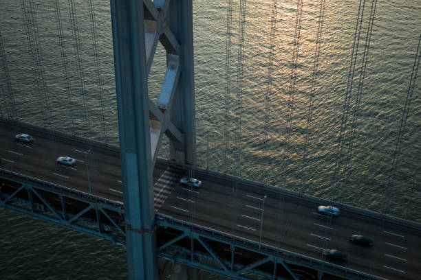 An aerial shot of the San Francisco-Oakland Bay Bridge taken by drone at sunset.