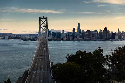 An aerial view of the San Francisco skyline seen from the San Francisco-Oakland Bay Bridge in the evening.