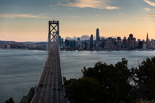 An aerial view of the San Francisco skyline seen from the San Francisco-Oakland Bay Bridge in the evening.