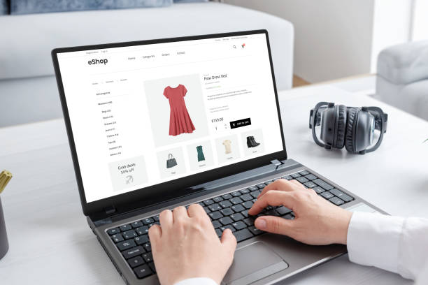 istock Woman purchasing a stunning red dress online with laptop computer. Modern ecommerce web page interface 1499059935