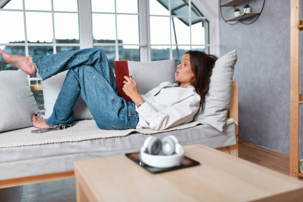 istock Female Enjoying New Book At Home 1499060420
