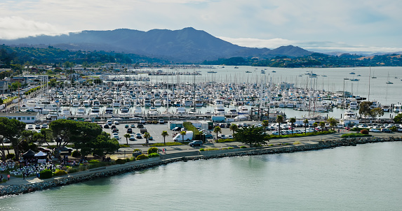 An aerial view of yachts and boats in the Sausalito harbor during the day.