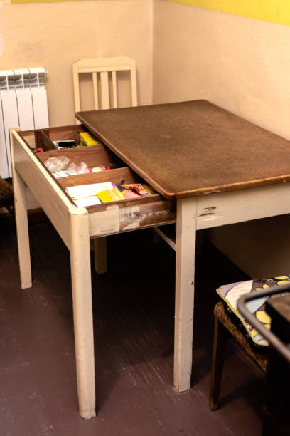 Antique kitchen table with a pull-out drawer with tools and personal things