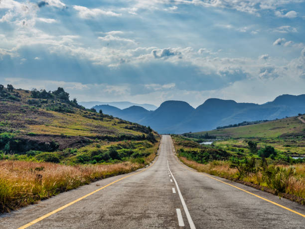 istock Road through rolling hills and mountain peaks with dramatic sky sun rays on Panorama Route, Mpumalanga, South Africa 1499063833