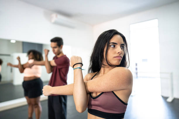 istock Young woman stretching in a dance studio 1499065813