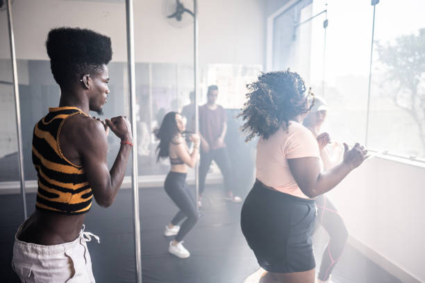 Young people in a dancing class at a dance studio Young people in a dancing class at a dance studio black pole dancers stock pictures, royalty-free photos & images