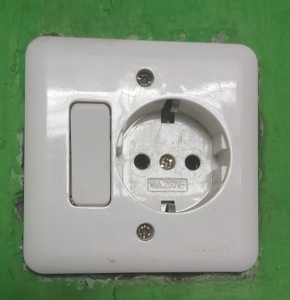 Portrait electric socket and light switch on wall