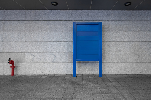 Blue signs and Fire hydrant in the passageway outside the station