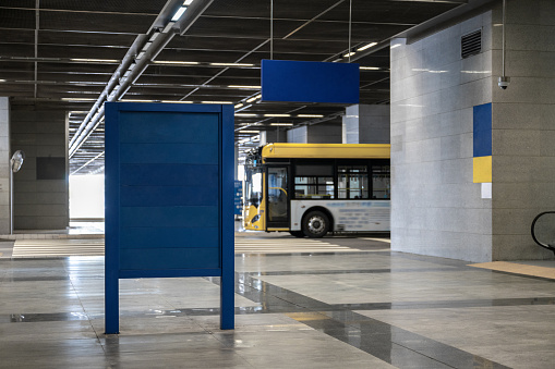 Augsburg, Germany, 08/23/2019: Modern illuminated bus station at the Koenigsplatz in Augsburg.\nThe special feature is that as soon as all trams are ready to leave the Kö, the lighting changes  from normal blue light to green light.